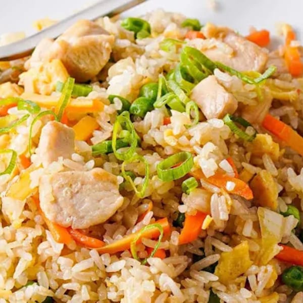 Close-up of chicken fried rice with peas, carrots, and green onions, served at HALAL CHINESE INDO PAK RESTAURANT.